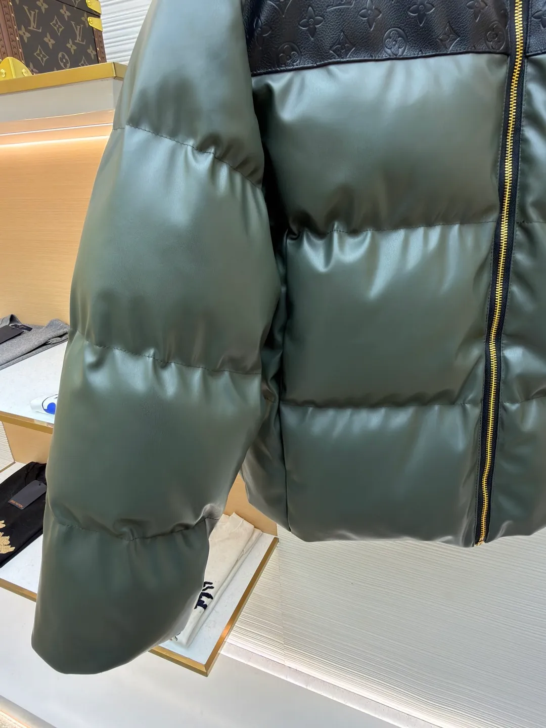 LOUIS VUITTON embossed splicing down jacket ●Original version: purchased and developed at 39599 ●Item number: 1682246-D35 ●Fabric: cotton fabric ●Technology: embossed production ●Version: fitted version ●Weight: about 1455 grams ●Size: 46-48-50-52 ●Description: This Louis Vuitton color-blocked down jacket is made with high-end craftsmanship. The main body of the jacket is made of high-grade artificial leather with a matte texture. It has been treated with water-repellent treatment and softened and polished multiple times. It has a delicate touch and is wrinkle-resistant. The shoulders and collar are spliced with black leather embossed with the classic Monogram pattern. The embossing process is hot-pressed with a precise temperature-controlled mold. The pattern has a uniform depth and a three-dimensional outline, restoring the brand's iconic elements. The filling layer adopts the golden ratio of 90% white goose down and 10% feathers. It is manually filled through the divided down filling process. The amount of down in each grid is precisely controlled to ensure that the warmth and fluffiness are evenly distributed. The metal zipper is made of custom-made brass and has been treated with gold-plated anti-oxidation treatment. The zipper teeth have high tightness and smooth pulling. The neckline is cut with a stand-up collar, which is fixed with three-dimensional stitching technology. The overall stitching adopts double-needle overlocking technology. The stitching is fine and flat, taking into account durability and light luxury texture. The details show the brand's ingenious craftsmanship. The overall wiring is straight and delicate, the fabric is comfortable and soft, and the color is consistent without color difference. It can be matched with the same style to create a fashionable look and control various occasions. Customized accessories, complete with three standards, same style for men and women!